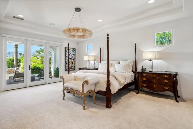 a bedroom with a bed and a lamp on desk