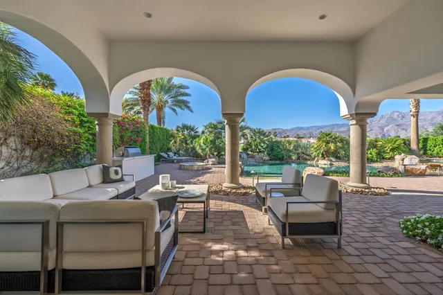 a front view of a house with a yard table and chairs
