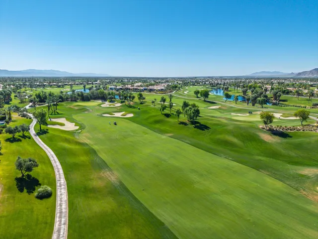 a living room with furniture a chandelier and a large window