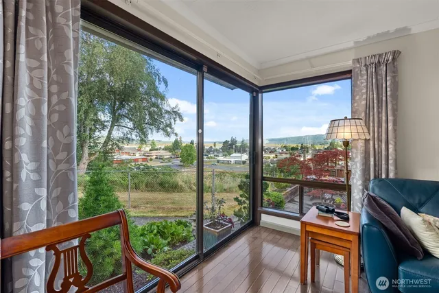 a room with a large window and a balcony