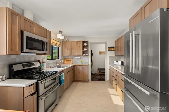 a kitchen with a refrigerator stove and sink