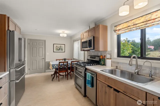 a kitchen with stainless steel appliances granite countertop a sink stove and microwave