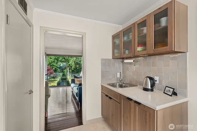 a kitchen with a sink a refrigerator and a window