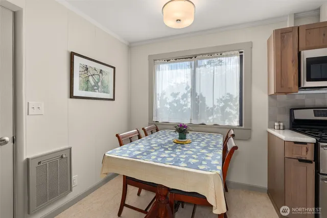 a dining room with a table and chairs