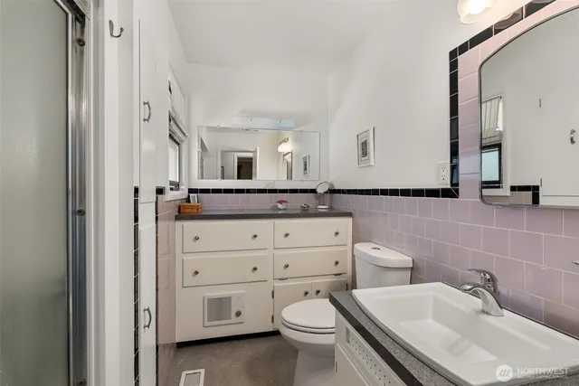 a bathroom with a toilet sink and mirror
