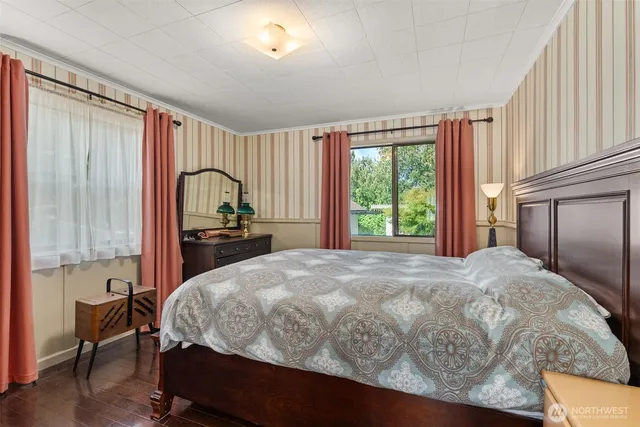 a bedroom with a bed window and a dresser
