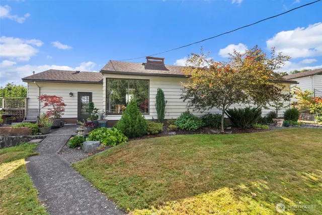 a front view of a house with a garden