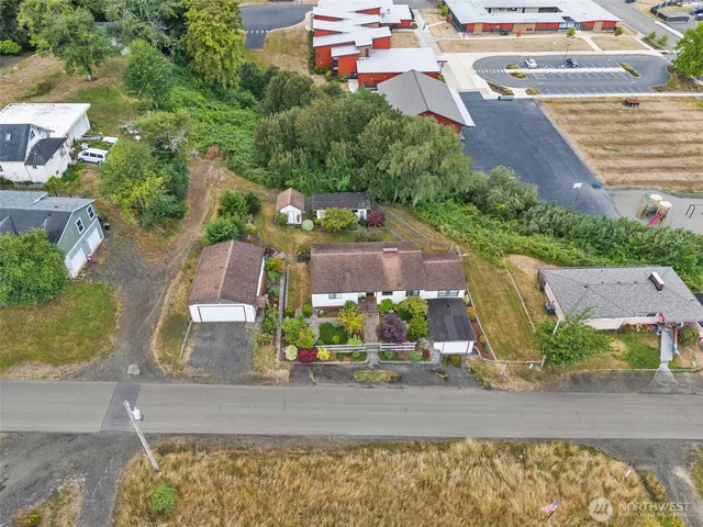 an aerial view of a house with a yard basket ball court and outdoor seating