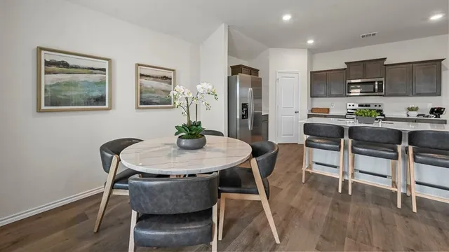 a view of a dining room with furniture and wooden floor