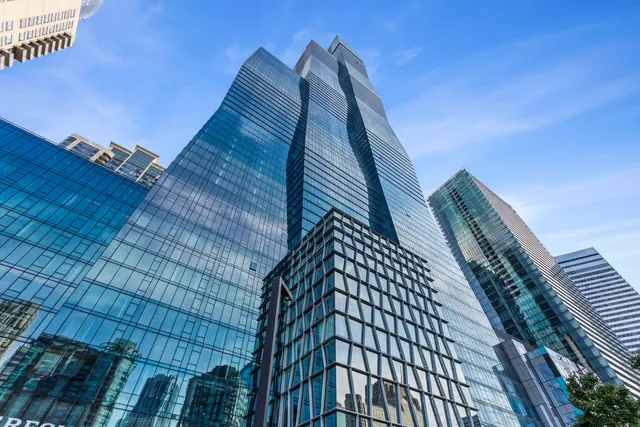a living room with furniture flat screen tv and a large window