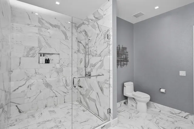 a bathroom with a double vanity sink toilet and mirror