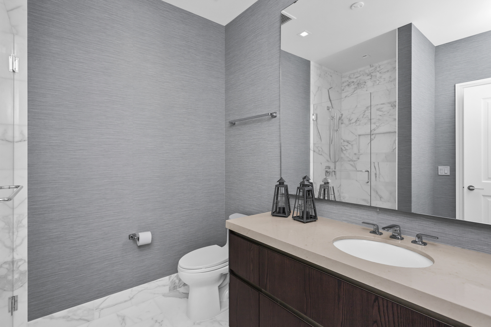 363 East Wacker Drive, Unit 2503 Chicago, IL 60601 - Photo 23 of 52 a bathroom with a double vanity sink toilet and mirror