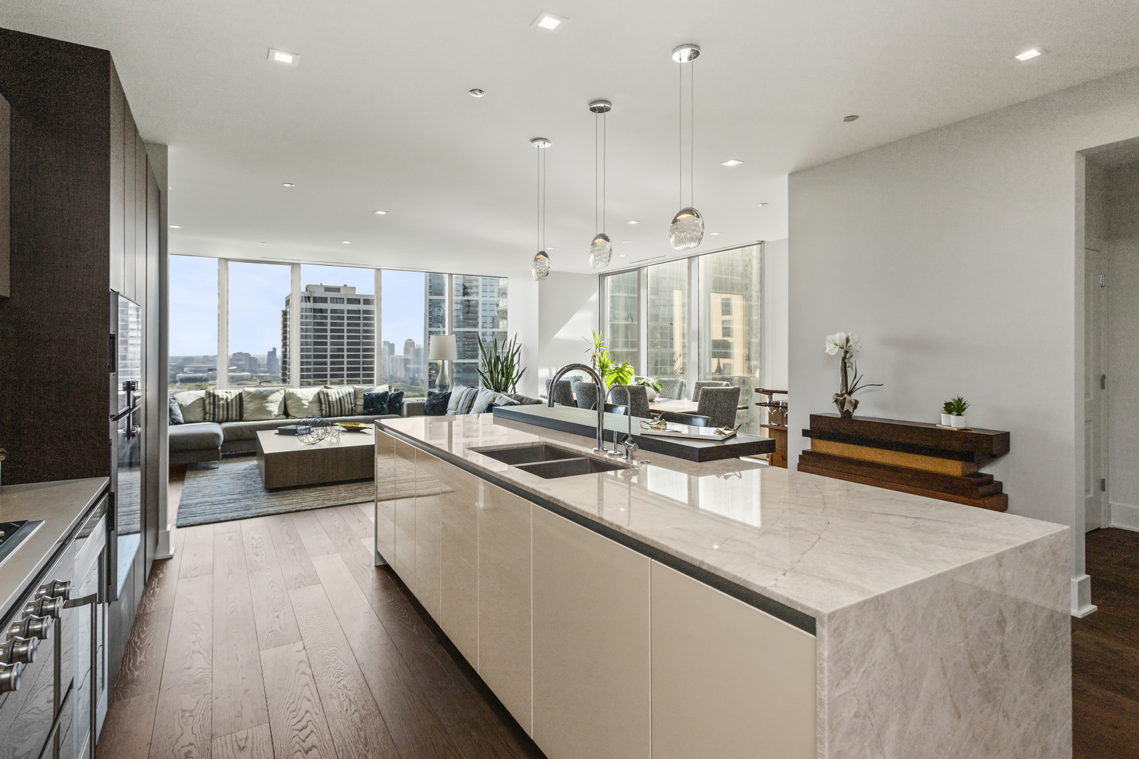 363 East Wacker Drive, Unit 2503 Chicago, IL 60601 - Photo 3 of 52 a view of a kitchen with kitchen island granite countertop a large counter top space a sink stainless steel appliances and windows