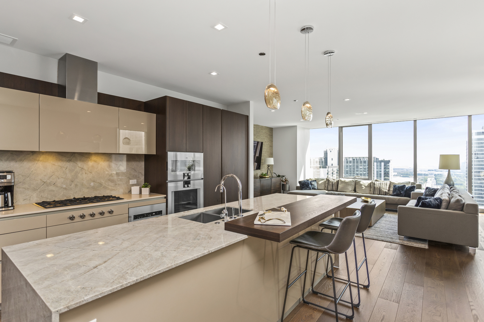 363 East Wacker Drive, Unit 2503 Chicago, IL 60601 - Photo 9 of 52 a kitchen with stainless steel appliances granite countertop a stove top oven a sink a dining table and chairs with wooden floor