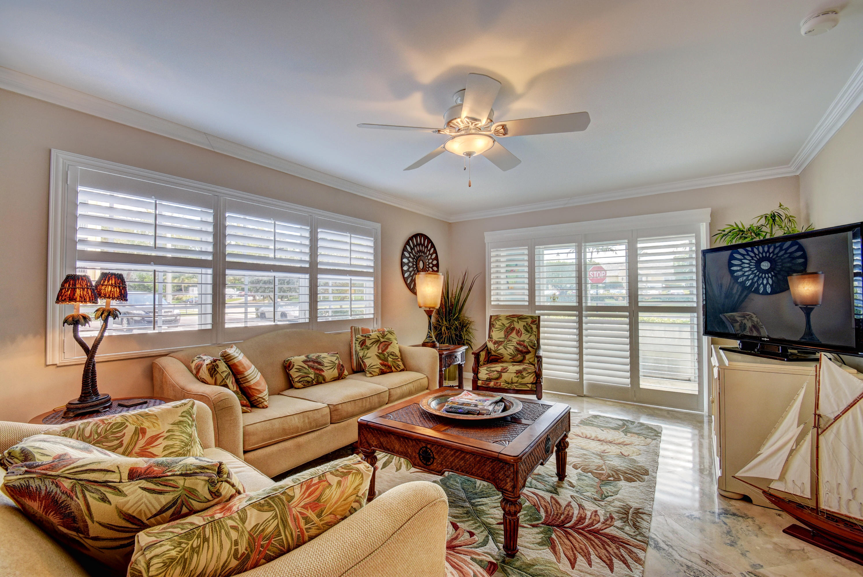 1700 South Ocean Boulevard, Unit 7 Delray Beach, FL 33483 - Photo 12 of 37 a living room with furniture a flat screen tv and a large window