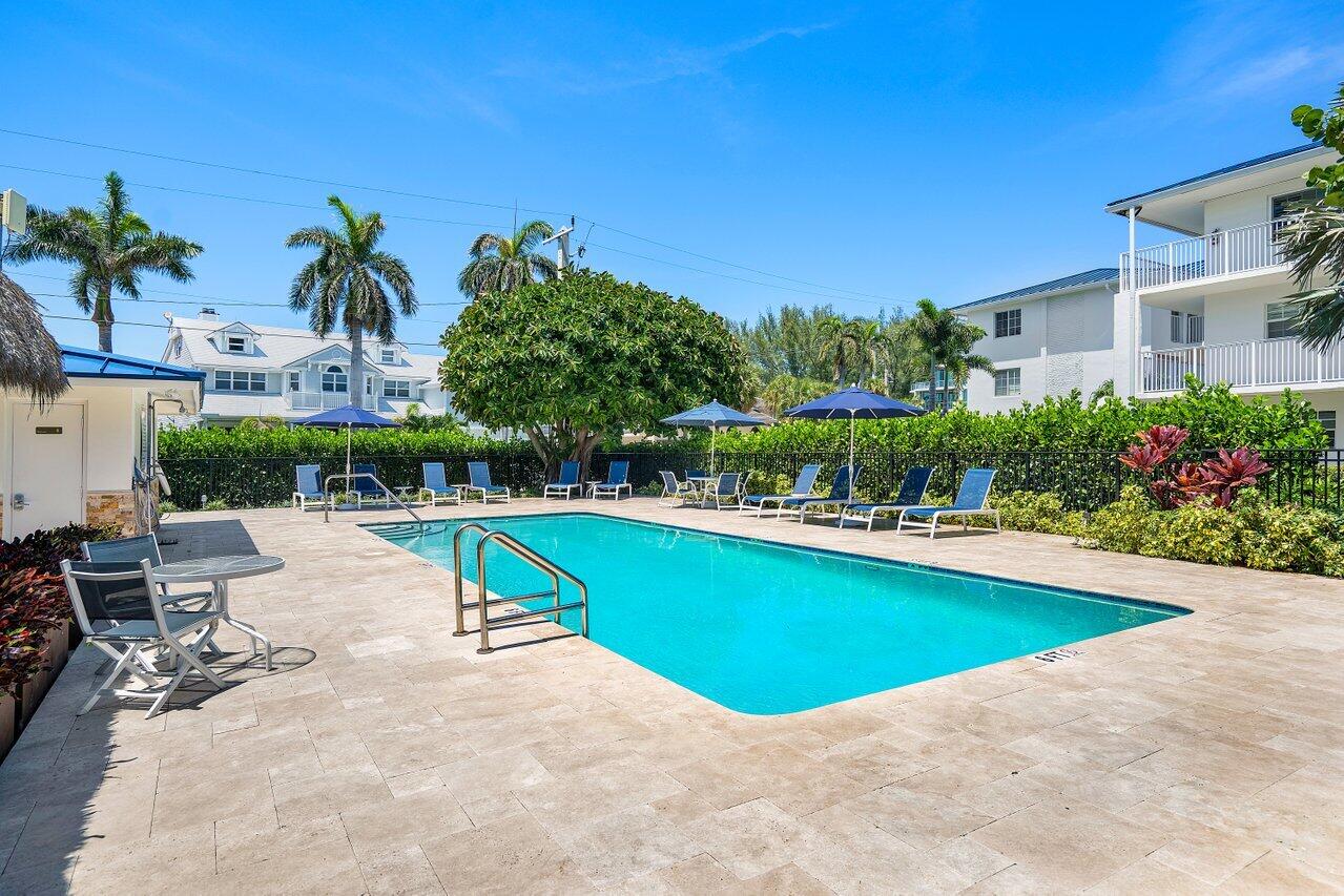1700 South Ocean Boulevard, Unit 7 Delray Beach, FL 33483 - Photo 21 of 37 a view of a swimming pool with lounge chair