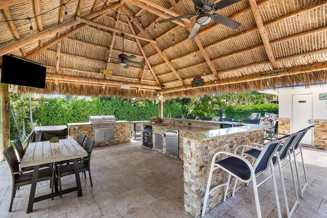 a view of a patio with table and chairs and potted plants