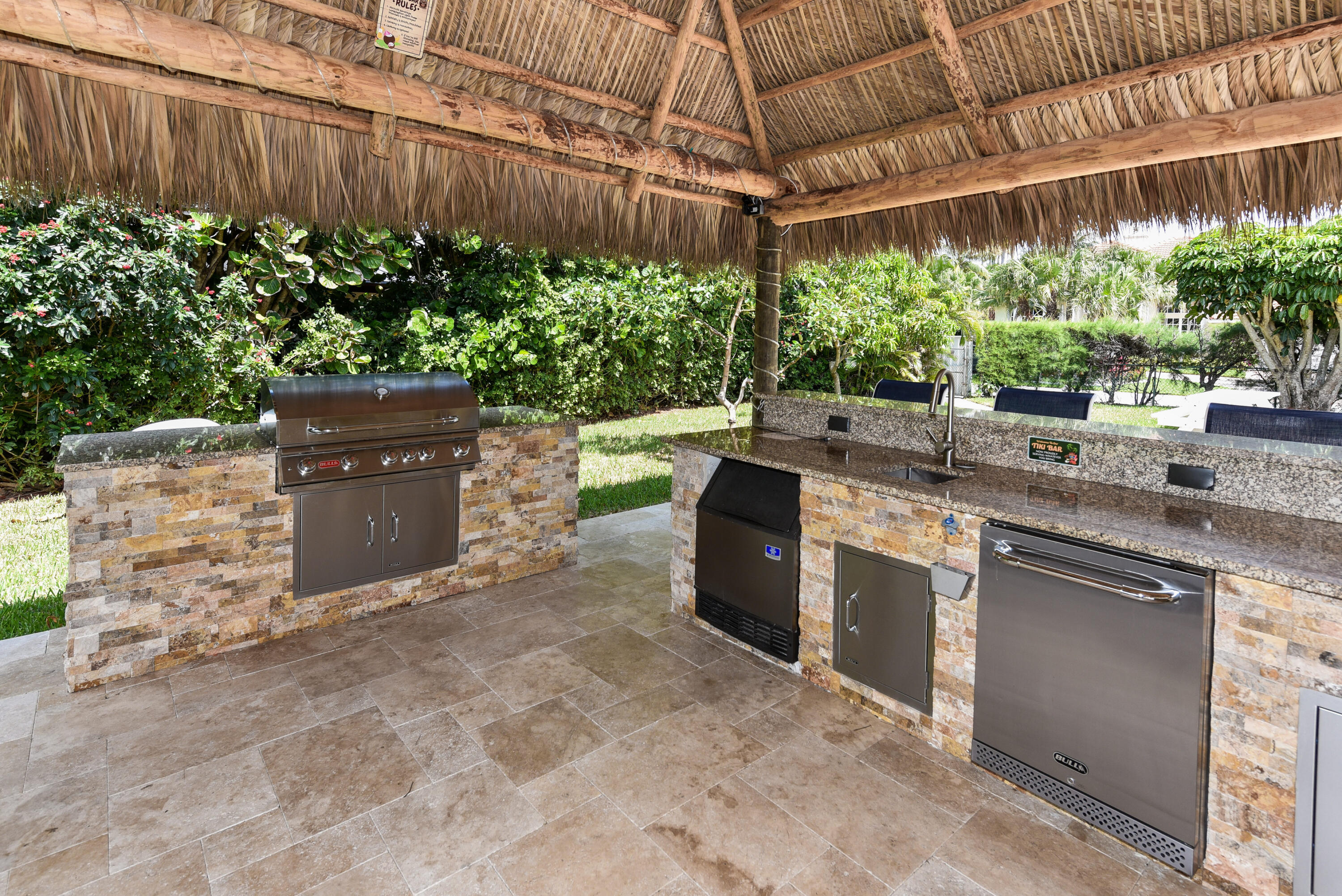 1700 South Ocean Boulevard, Unit 7 Delray Beach, FL 33483 - Photo 27 of 37 a kitchen with stainless steel appliances kitchen island a table and chairs in it