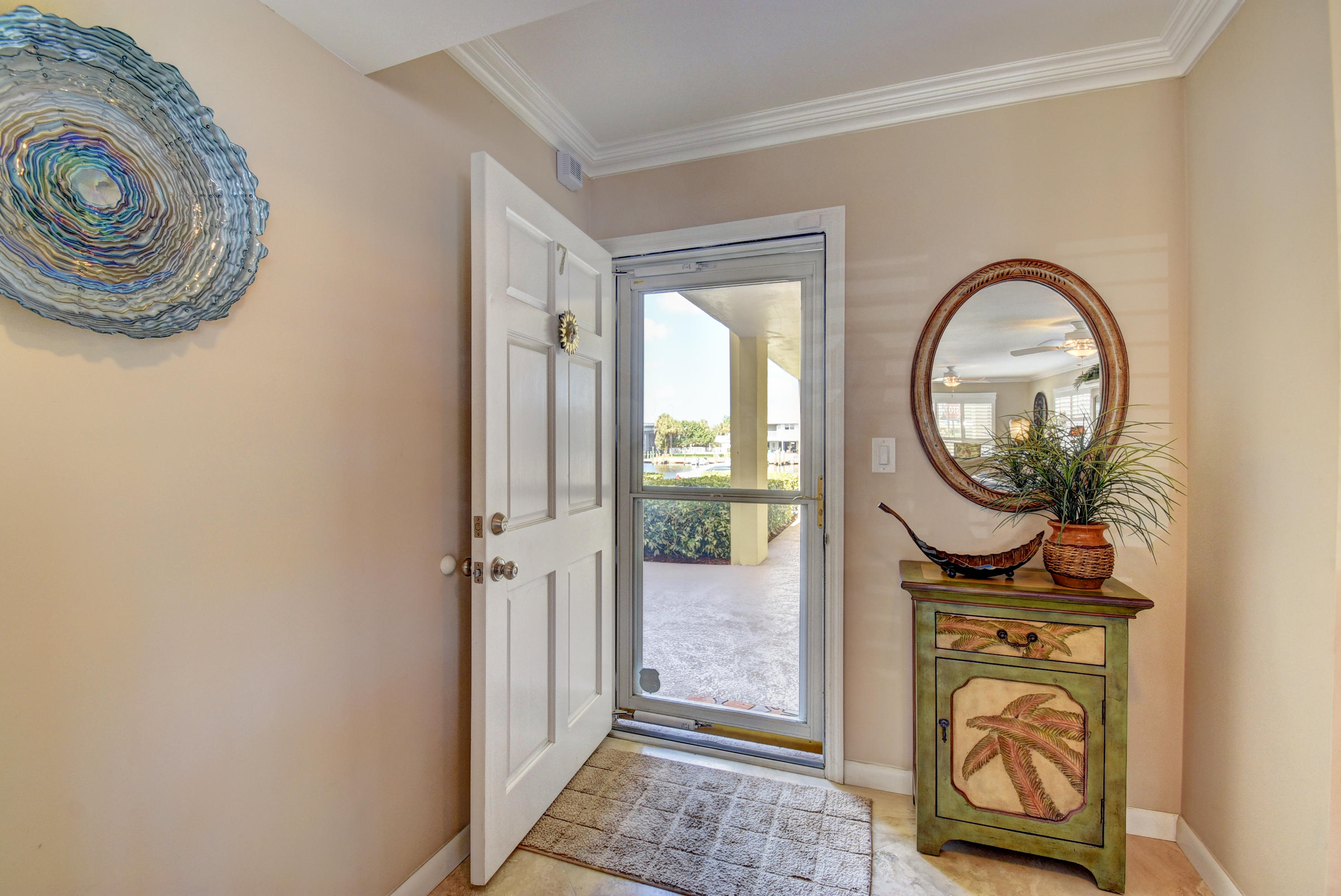 1700 South Ocean Boulevard, Unit 7 Delray Beach, FL 33483 - Photo 3 of 37 a front view of a house with a garden