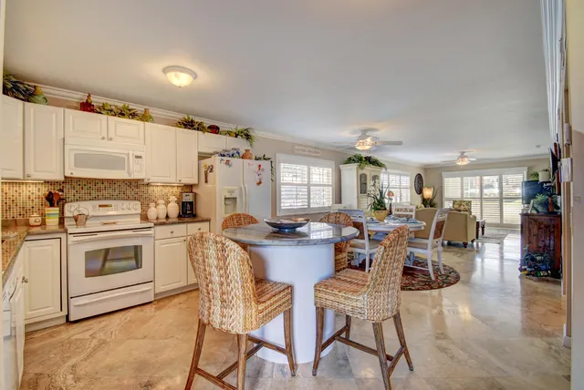 a kitchen with a table chairs stove and cabinets