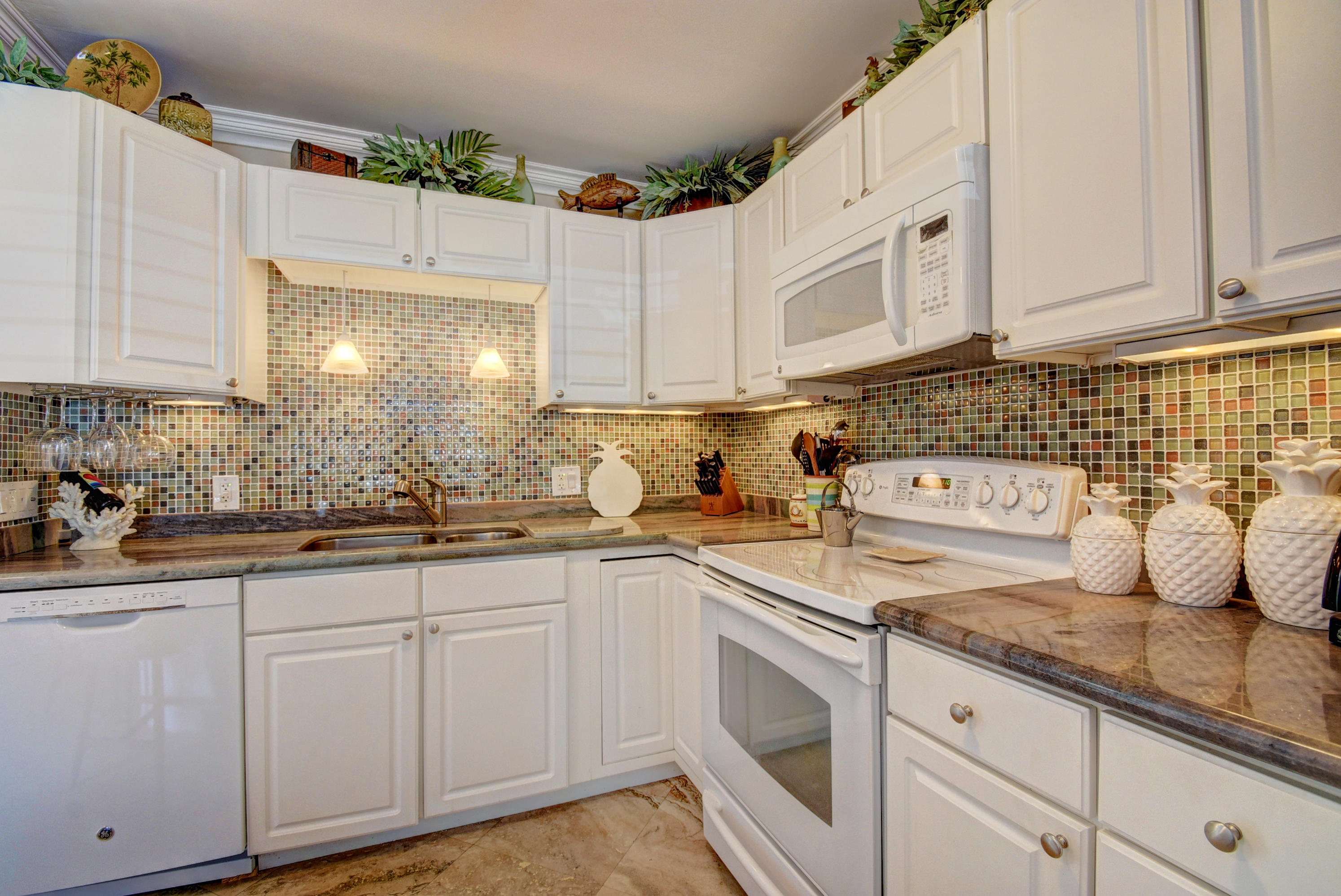 1700 South Ocean Boulevard, Unit 7 Delray Beach, FL 33483 - Photo 6 of 37 a kitchen with stainless steel appliances granite countertop a sink a stove and cabinets