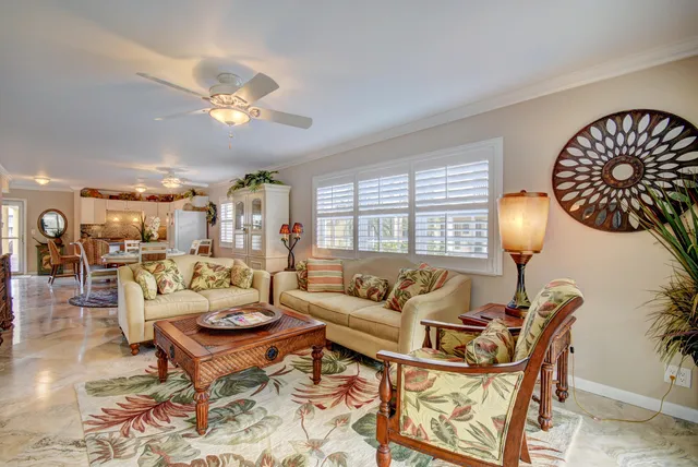 a living room with furniture a lamp and a large window