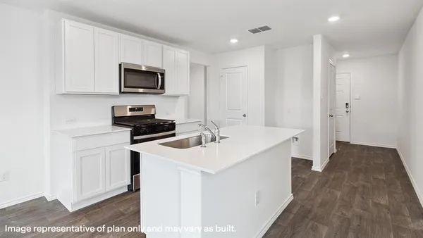 a kitchen with a sink stove and microwave