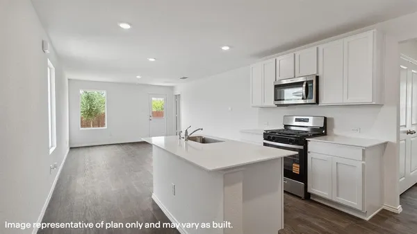a kitchen with stainless steel appliances a sink stove and cabinets
