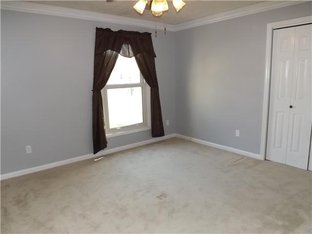 165 Mortons Lake Road Manchester, TN 37355 - Photo 13 of 18 The third bedroom also has a ceiling fan, crown molding and a sunny window.