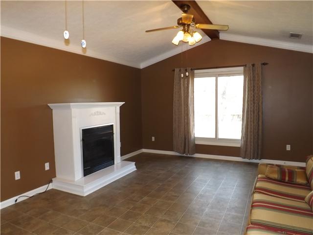 165 Mortons Lake Road Manchester, TN 37355 - Photo 4 of 18 A gathering room with gas fireplace adjoins the kitchen and opens to a screened deck.