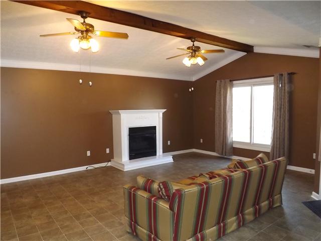 165 Mortons Lake Road Manchester, TN 37355 - Photo 5 of 18 This view of the Gathering Room features the vaulted ceiling with beams and ceiling fans.