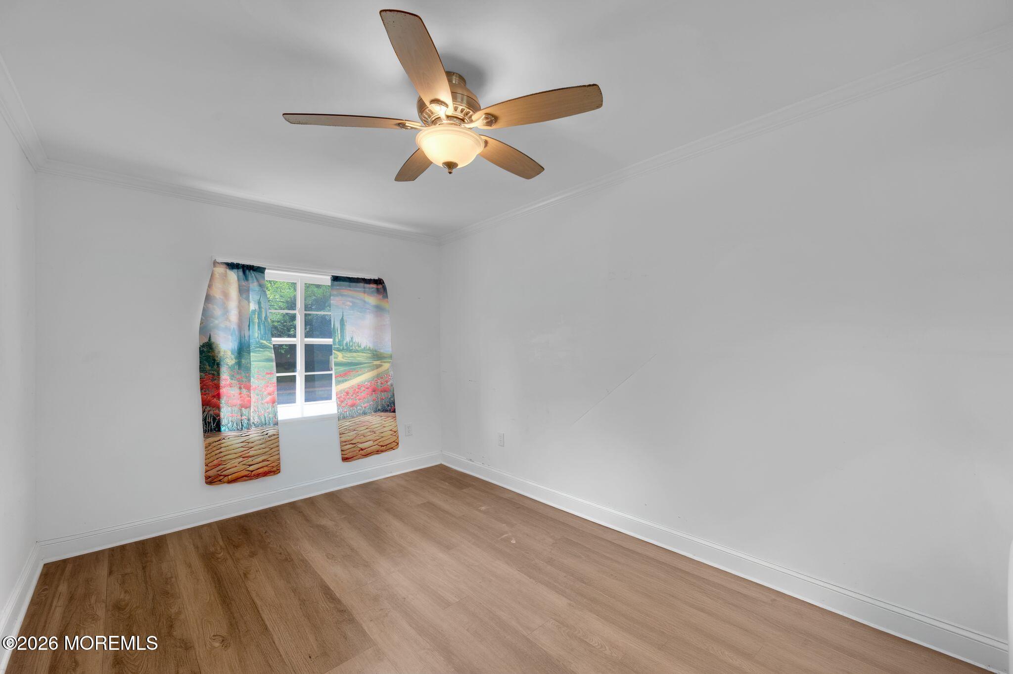 2604 Logan Road Asbury Park, NJ 07712 - Photo 14 of 39 an empty room with wooden floor and windows