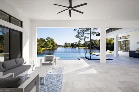 a living room with furniture and a floor to ceiling window