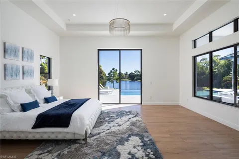 a living room with a bed furniture and next to a window