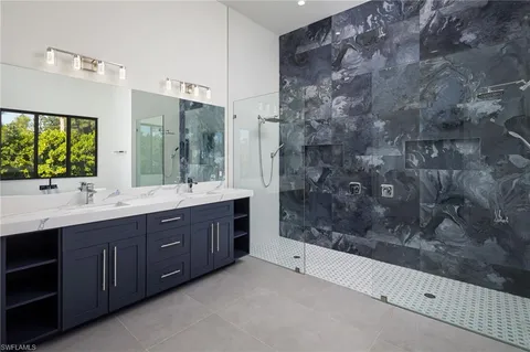 a spacious bathroom with a sink mirror and shower