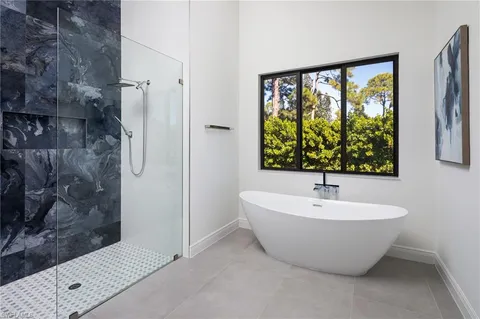 a bathroom with a bathtub and shower