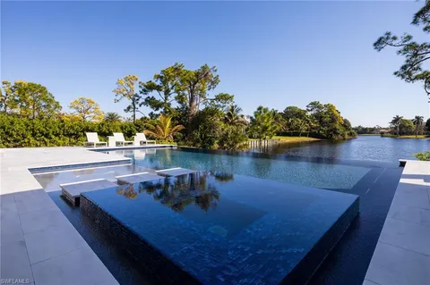 swimming pool view with a lake view
