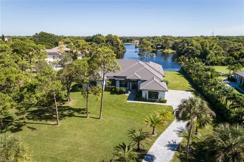 an aerial view of residential houses with yard