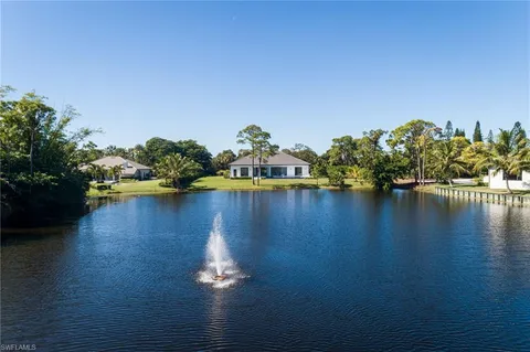 a view of a lake with chairs