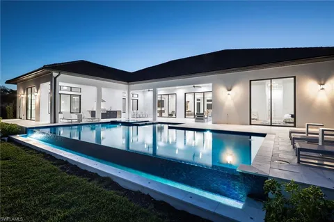 a view of swimming pool with outdoor seating