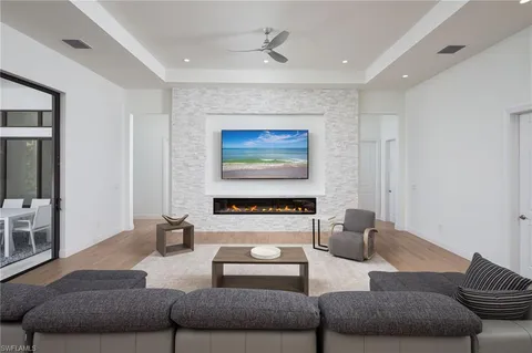 a living room with furniture and a chandelier