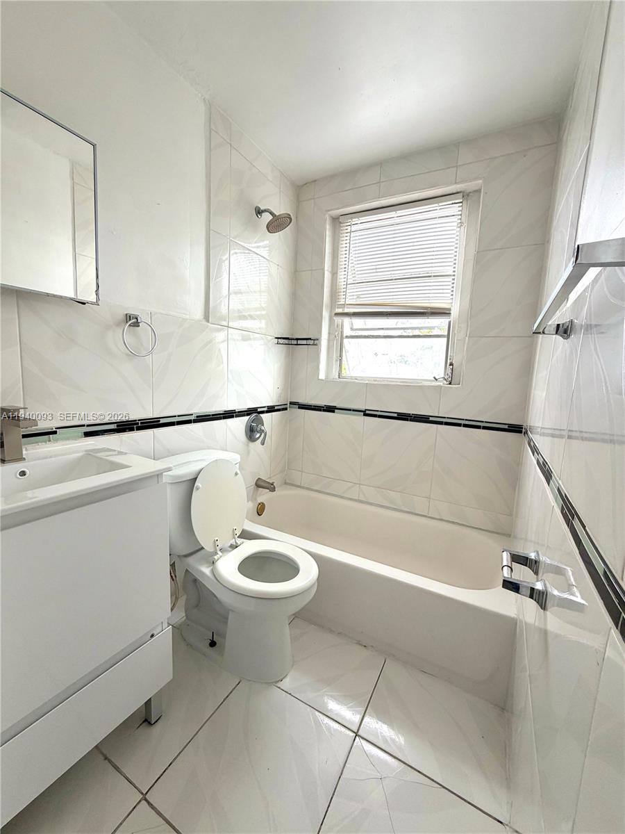 967 Southwest 5th Street, Unit 18 Miami, FL 33130 - Photo 11 of 12 a bathroom with a sink a toilet and shower