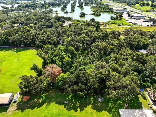 an aerial view of residential houses with outdoor space and swimming pool