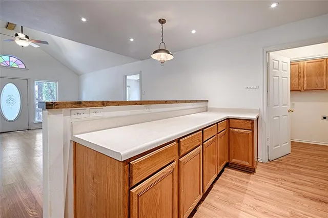 a view of a kitchen with a sink and a chandelier
