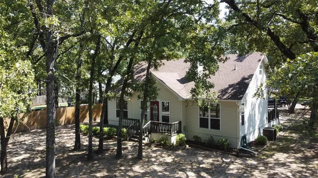 a view of house with a tree in front