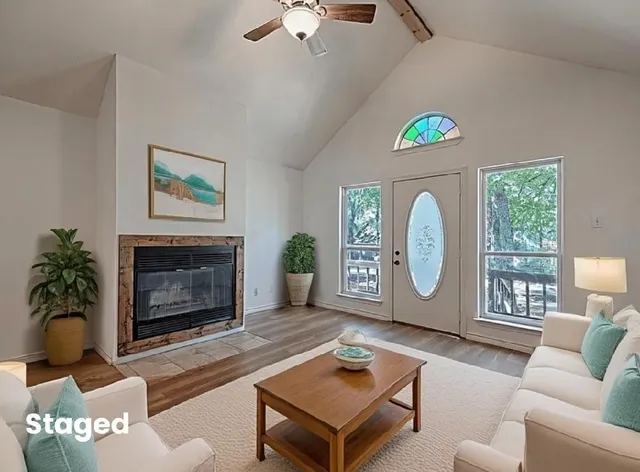 a living room with furniture a window and a fireplace