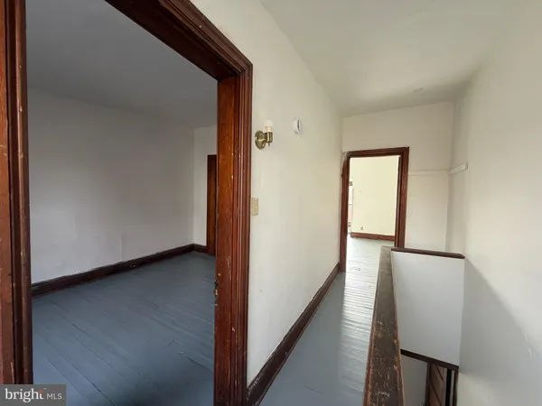 an empty room with wooden floor and closet