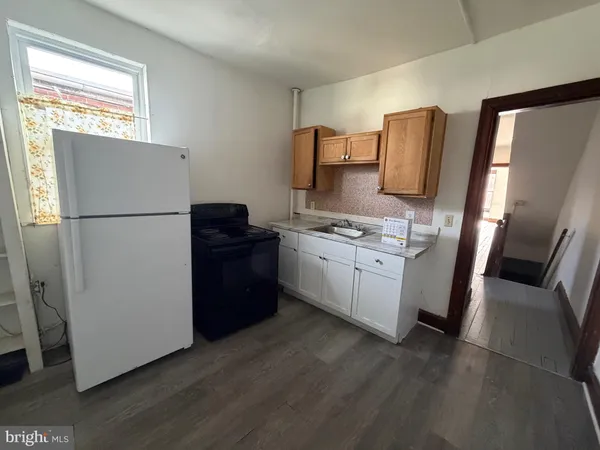 a white refrigerator freezer sitting inside of a kitchen