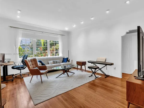 a living room with furniture and a wooden floor