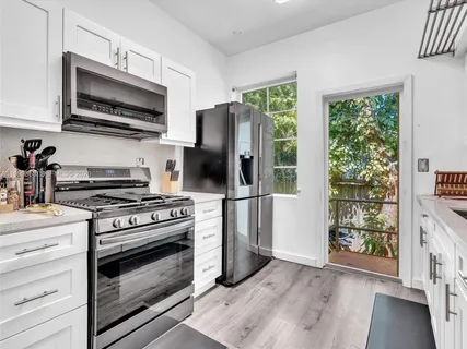 a kitchen with a stove a microwave and refrigerator